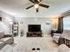 Open living room featuring a ceiling fan, neutral color scheme, wood floors, and comfortable seating arrangement at 11722 Carissa Ln # 49A, New Port Richey, FL 34654