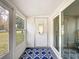 Sunroom with a mirror and white door offering bright views of the outdoor space at 11722 Carissa Ln # 49A, New Port Richey, FL 34654