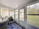 Bright sunroom featuring a blue rug, wicker chairs, and large windows overlooking the backyard at 11722 Carissa Ln # 49A, New Port Richey, FL 34654