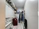 Organized walk-in closet with white shelving and ample storage space for clothes and accessories at 11722 Carissa Ln # 49A, New Port Richey, FL 34654