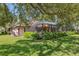 Secluded backyard showcasing a screened-in pool area, surrounded by greenery and mature trees at 12295 Clarendon Ct, Spring Hill, FL 34609