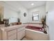 Well-lit bathroom featuring garden tub and vanity at 12295 Clarendon Ct, Spring Hill, FL 34609