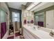 Bathroom featuring a large mirror, vanity with storage, shower, and coordinated decor accents at 12295 Clarendon Ct, Spring Hill, FL 34609