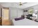 Bright bedroom boasts neutral walls, closet space, and a dedicated workspace under a ceiling fan at 12295 Clarendon Ct, Spring Hill, FL 34609