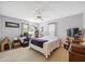 Cozy bedroom featuring a ceiling fan, neutral walls, and a functional workspace area with a computer at 12295 Clarendon Ct, Spring Hill, FL 34609