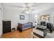 Comfortable bedroom with wood floors, a twin bed, and a workspace with natural light streaming through the window at 12295 Clarendon Ct, Spring Hill, FL 34609