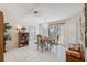 Bright dining area with tile floors, chandelier, view of the backyard, and sliding door access at 12295 Clarendon Ct, Spring Hill, FL 34609