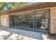 View of the home's expansive screened-in garage, providing ample space for vehicles and storage at 12295 Clarendon Ct, Spring Hill, FL 34609