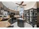 Well-equipped kitchen with black cabinets, granite countertops, a central island, and modern stainless-steel appliances at 12295 Clarendon Ct, Spring Hill, FL 34609