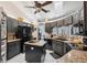 Well-equipped kitchen with black cabinets, granite countertops, a central island, and modern stainless-steel appliances at 12295 Clarendon Ct, Spring Hill, FL 34609
