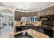 Well-lit kitchen with gray cabinetry, granite countertops, and stainless steel appliances at 12295 Clarendon Ct, Spring Hill, FL 34609
