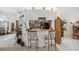 A charming pass through kitchenette complete with bar seating and an opening into a full kitchen at 12295 Clarendon Ct, Spring Hill, FL 34609