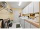 Laundry room equipped with a washer, dryer, sink, and ample cabinet storage for household essentials at 12295 Clarendon Ct, Spring Hill, FL 34609