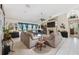 Spacious living room featuring a fireplace, tile flooring, and large windows that provide plenty of natural light at 12295 Clarendon Ct, Spring Hill, FL 34609