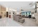 Bright and airy living room featuring high ceilings, a ceiling fan, and comfortable seating at 12295 Clarendon Ct, Spring Hill, FL 34609