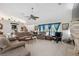 Bright and airy living room featuring high ceilings, a ceiling fan, and comfortable seating at 12295 Clarendon Ct, Spring Hill, FL 34609