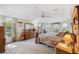 Spacious main bedroom with carpet floors, ceiling fan, and a large window with views of nature at 12295 Clarendon Ct, Spring Hill, FL 34609