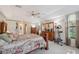 Spacious main bedroom with carpet floors, ceiling fan, and a large window with views of nature at 12295 Clarendon Ct, Spring Hill, FL 34609