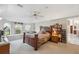 Spacious main bedroom with carpet floors, ceiling fan, and a large window with views of nature at 12295 Clarendon Ct, Spring Hill, FL 34609