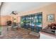 Inviting outdoor patio with seating, an outdoor kitchen area, and views of the screened-in pool at 12295 Clarendon Ct, Spring Hill, FL 34609
