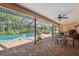 Enjoy the screened-in pool area, complete with a patio, seating, and lush green landscaping at 12295 Clarendon Ct, Spring Hill, FL 34609
