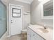 Bathroom with walk-in shower, white vanity, and an exterior door at 13125 Jessica Dr, Spring Hill, FL 34609