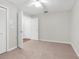 Cozy bedroom with neutral decor and carpeting features a ceiling fan and spacious closets at 13125 Jessica Dr, Spring Hill, FL 34609
