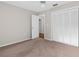 Bright bedroom with plush carpeting, ceiling fan, and closet with louvered doors at 13125 Jessica Dr, Spring Hill, FL 34609