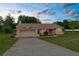 Charming single-story home featuring a well-manicured lawn and attached two-car garage at 13125 Jessica Dr, Spring Hill, FL 34609