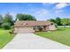 Charming single-story home featuring a well-manicured lawn and attached two-car garage at 13125 Jessica Dr, Spring Hill, FL 34609