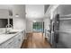 Open kitchen with modern appliances, leading to the dining area and backyard pool at 13125 Jessica Dr, Spring Hill, FL 34609