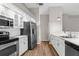 Modern kitchen featuring stainless steel appliances, white cabinets, and a sleek countertop at 13125 Jessica Dr, Spring Hill, FL 34609
