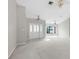 Spacious living room with white tile entry and neutral carpet, bathed in natural light at 13125 Jessica Dr, Spring Hill, FL 34609