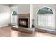 Living room showcasing fireplace with stone detail and natural light from large windows at 13125 Jessica Dr, Spring Hill, FL 34609
