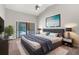 Beautiful main bedroom with modern decor, sliding glass door and vaulted ceiling at 13125 Jessica Dr, Spring Hill, FL 34609