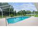 Screened-in pool with a sunny and well-maintained pool area at 13125 Jessica Dr, Spring Hill, FL 34609