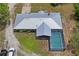 The property features a home, screened-in pool, and is surrounded by trees at 13345 Convent Garden Rd, Brooksville, FL 34613