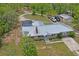 The single-story home has a metal roof, screened-in pool, and adjacent parking at 13345 Convent Garden Rd, Brooksville, FL 34613