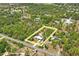 Expansive aerial view of the property highlighting the home, surrounding trees, and yellow property lines at 13345 Convent Garden Rd, Brooksville, FL 34613