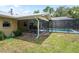 View of the backyard featuring a screened-in patio and pool area at 13345 Convent Garden Rd, Brooksville, FL 34613