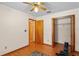 Bedroom with ceiling fan, laminate floors, closet and natural light from windows at 13345 Convent Garden Rd, Brooksville, FL 34613