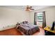 Cozy bedroom featuring a ceiling fan, window, and comfortable bed with camo-themed bedding at 13345 Convent Garden Rd, Brooksville, FL 34613