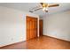Empty bedroom with ceiling fan, closet, wood-look flooring and access to the bathroom at 13345 Convent Garden Rd, Brooksville, FL 34613