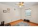 Bedroom with ceiling fan, laminate floors, and natural light from the window at 13345 Convent Garden Rd, Brooksville, FL 34613