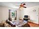 This comfy bedroom has a fan, window overlooking the backyard, and a wall-mounted tv at 13345 Convent Garden Rd, Brooksville, FL 34613