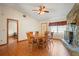 Dining room featuring a stone fireplace, wood floors, view of entryway and view into a bedroom at 13345 Convent Garden Rd, Brooksville, FL 34613