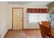 Entryway with tile floors, wood trim door, and glimpse into the dining room featuring a stone fireplace at 13345 Convent Garden Rd, Brooksville, FL 34613