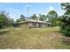 Charming ranch-style home with stone accents, a screened porch, and mature landscaping at 13345 Convent Garden Rd, Brooksville, FL 34613