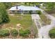 This charming single story house features yellow stone accents, an American flag, and a paved driveway at 13345 Convent Garden Rd, Brooksville, FL 34613