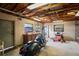 Garage interior with motorcycle, lawnmower, and ample storage at 13345 Convent Garden Rd, Brooksville, FL 34613